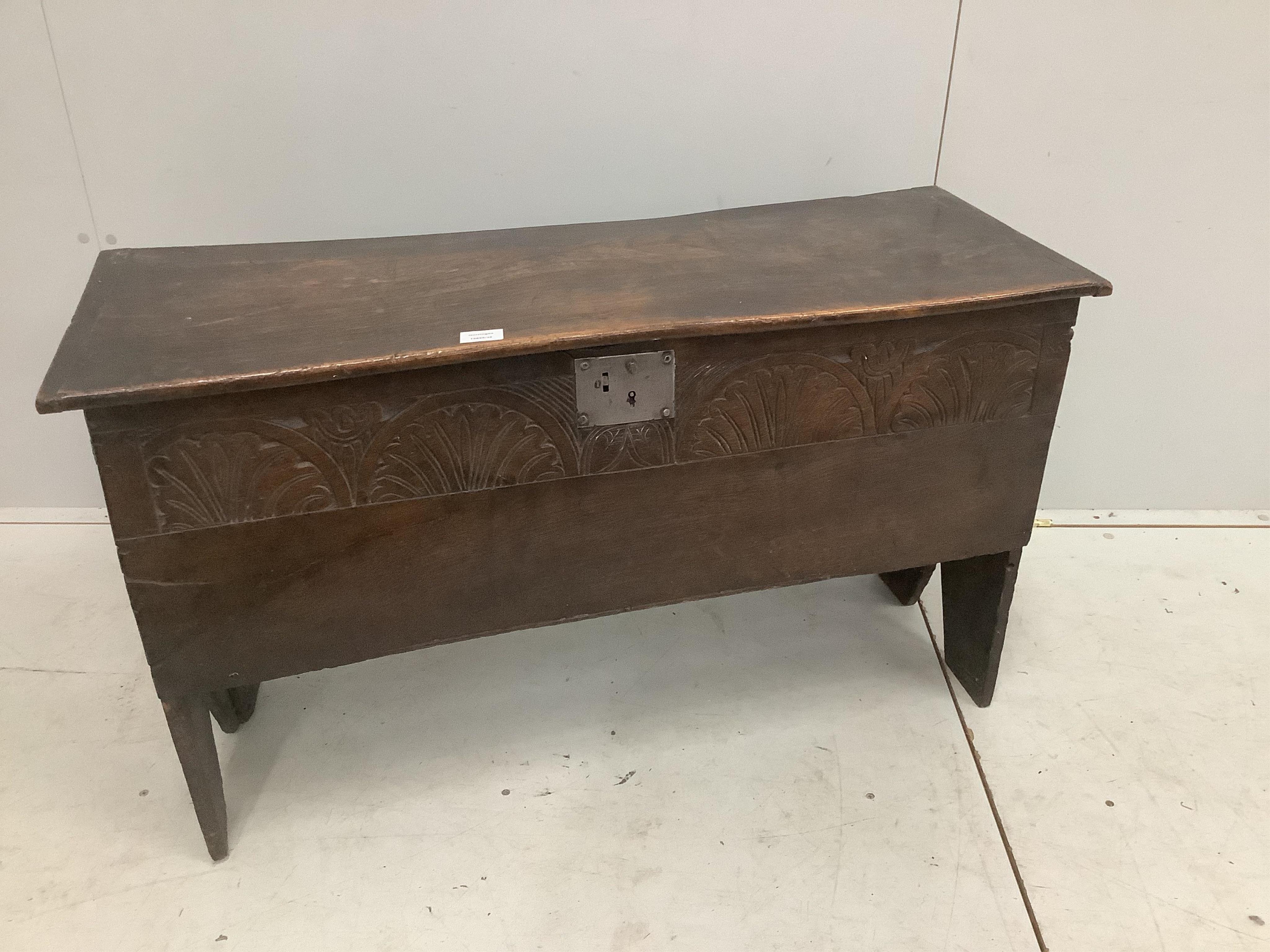 An early 18th century oak six plank coffer, with a lunette carved front, width 103cm, depth 38cm, height 61cm. Condition - fair